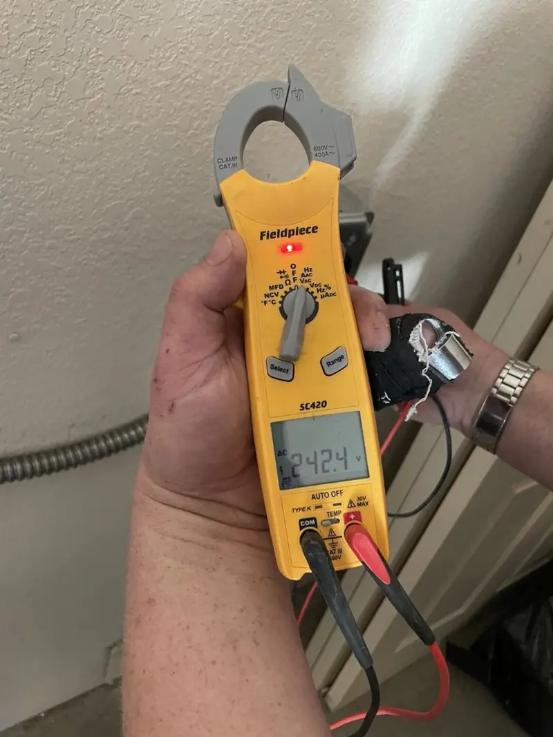 Voltage testing with clamp meter during Electrical Installation Services in Raymondville